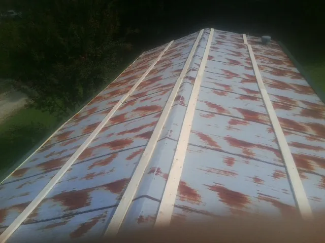 Rusted metal roof panels with new wood purlins before replacement — Storm Damage Roof Repair in Coppell by Roofing Brothers